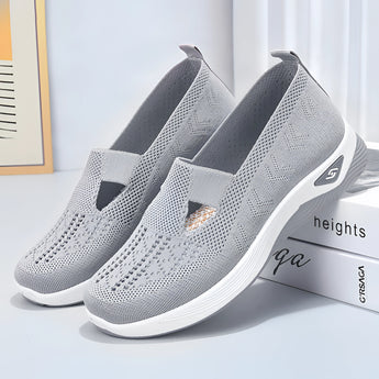 Stylish women's gray slip-on sneakers in size 42, featuring a lightweight and breathable design ideal for outdoor activities and walking.