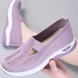 Stylish women's slip-on sneakers in light violet, featuring a lightweight and breathable design with a sleek, athletic look.