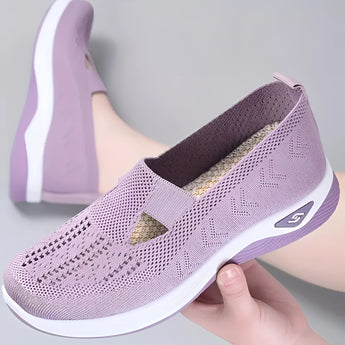 Stylish women's slip-on sneakers in light violet, featuring a lightweight and breathable design with a sleek, athletic look.