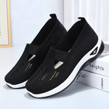 Stylish women's black slip-on sneakers designed for lightweight comfort and breathability, ideal for walking and outdoor activities.