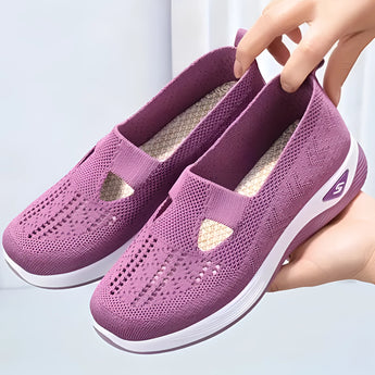 Stylish women's black slip-on sneakers in size 42 with a purple accent, designed for lightweight and breathable comfort, made with synthetic rubber material suitable for outdoor activities and walking.