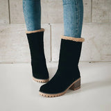 Stylish women's black suede winter boots with shearling lining, featuring a sleek design ideal for cold weather fashion.