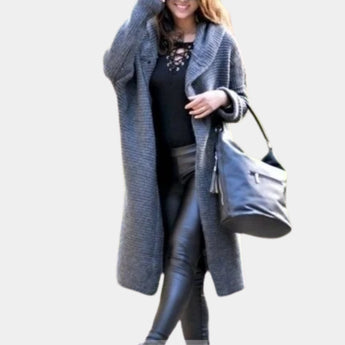 A stylish women's gray hooded vest worn by a smiling model, featuring bold textured winter wear design, knee-length coverage, and a collar.