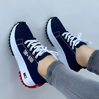 Stylish women's white sneakers with a vibrant red sole, shown in a navy blue variant, size 43, designed for trendy urban fashion.