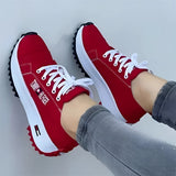 Stylish white women's sneakers with a distinctive red sole, designed for trendy urban fashion, shown in size 43.