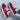 Stylish white women's sneakers with a distinctive red sole, designed for trendy urban fashion, shown in size 43.