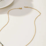 Artisan crafted sunburst pendant necklace in 18K gold, featuring a turquoise stone centerpiece with a circular design.
