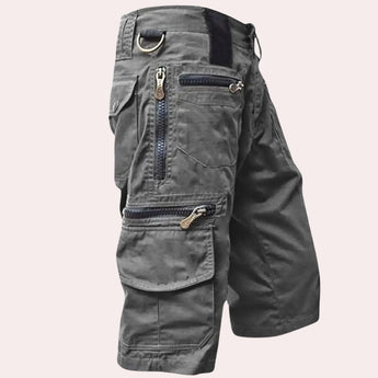 
Gray tactical cargo pants with multiple pockets and zippers, designed for outdoor use.