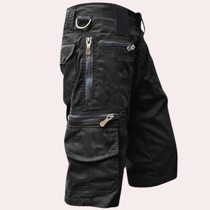Black tactical cargo pants with multiple pockets and zippers, designed for outdoor activities, available in size 3XL.