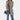 A woman wearing a gray tailored blazer in a 3XL size, styled over a dress shirt, showcasing a chic and versatile office look. The blazer features a sleek shoulder design and tailored sleeves, complemented by casual jeans, embodying a sophisticated yet relaxed style.