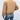Tan corduroy bomber jacket for women, perfect for trendy fall outerwear, featuring a comfortable textile with a classic bomber style including full sleeves and a waist-length design, worn by a person standing, paired with jeans and a dress shirt.