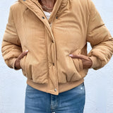 Tan corduroy bomber jacket for women displayed on a white background, showcasing its trendy fall style with a classic design featuring long sleeves and a comfortable fit.
