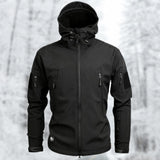 Black tactical hoodie in 2XL size, featuring a soft-shell design with water-resistant properties, modeled by a man with a beard wearing a grey cap. The hoodie has a structured collar and long sleeves.