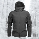 Gray tactical hoodie with a soft-shell, water-resistant design, featuring a military-grade construction. The hoodie includes elements such as a collar, long sleeves, and a comfortable fit, displayed on a human model.