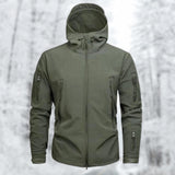 Green military-grade tactical hoodie in size 2XL, featuring an insulated soft-shell design with water-resistant properties. The image shows a close-up of a person wearing the hoodie, highlighting the shoulder, neck, and sleeve areas. The person also has a beard.