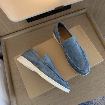 Taupe suede men's slip-on loafers on a hardwood floor, featuring a versatile and comfortable design in blue, size 47.