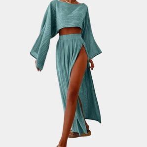 Teal bohemian beachwear set featuring a crop top with short sleeves and a high slit maxi skirt, highlighting the neck and waist areas, suitable for a stylish and relaxed look.