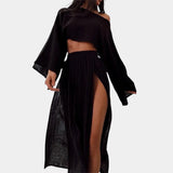 
A black bohemian beachwear set featuring a crop top with short sleeves and a high waist, paired with a high slit maxi skirt in size 3XL.