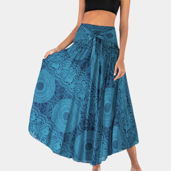 A woman wearing a teal bohemian floral lace A-line skirt, styled for summer festival wear. The skirt is blue, highlighting its intricate lace pattern and flowy design.