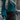 Teal cropped sweater paired with a black faux leather mini skirt, modeled by a woman, showcasing fall fashion attire.
