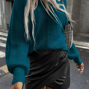 Teal cropped sweater paired with a black faux leather mini skirt, modeled by a woman, showcasing fall fashion attire.