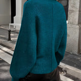 Teal cropped sweater paired with a black faux leather mini skirt, showcasing a stylish fall fashion look for women.