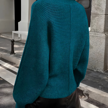 Teal cropped sweater paired with a black faux leather mini skirt, showcasing a stylish fall fashion look for women.