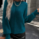 
Woman wearing a teal cropped sweater with long sleeves and a high neckline, paired with a faux leather mini skirt, styled for fall fashion. The sweater is a rich dark cyan color, and the ensemble is shown in a standing pose highlighting the waistline.