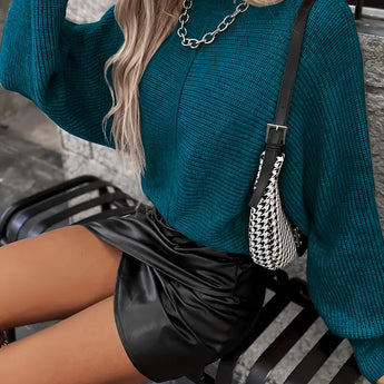 Teal cropped sweater paired with a black faux leather mini skirt, showcasing a stylish fall fashion look for women.