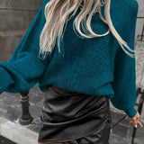 Teal cropped sweater paired with a black faux leather mini skirt, showcasing a stylish fall fashion outfit for women.