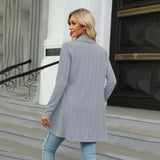 Teal long sleeve knit cardigan worn by a standing model, showcasing its stylish design perfect for fall fashion layering. The cardigan features a collar and covers the shoulders, waist, and knees.