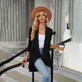 Teal long sleeve knit cardigan worn by a model, showcasing its shoulder and waist fit. The cardigan is styled with a sun hat and sunglasses, perfect for a trendy fall fashion look.
