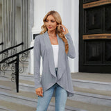 Teal long sleeve knit cardigan worn over a dress shirt, showcasing a stylish fall fashion layering piece.