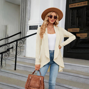 Teal long sleeve knit cardigan displayed on a mannequin, styled with a beige fedora hat and white eyewear, showcasing a trendy fall fashion layering piece.