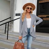 Teal long sleeve knit cardigan on a model, styled with a white fedora hat and sunglasses, showcasing a fashionable fall look.