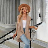 Teal long sleeve knit cardigan worn by a person standing, accessorized with a stylish fedora hat and sunglasses, showcasing fall fashion layering.