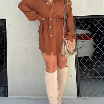 Teal oversized shirt dress styled with brown thigh-high suede boots, model wearing sunglasses.