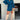 Teal oversized shirt dress paired with thigh-high suede boots, showcasing a casual chic style, worn by a model with eyewear.