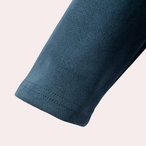 Teal soft fleece jacket with long sleeves, featuring a premium woolen texture and sustainable outdoor design.