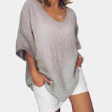 Gray oversized linen blouse with a V-neckline, featuring long sleeves and a loose fit suitable for a casual summer look.