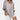 Gray oversized linen blouse with a V-neckline, featuring long sleeves and a loose fit suitable for a casual summer look.