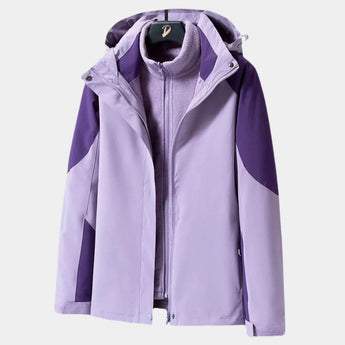 Teal women's waterproof breathable hiking jacket in a lightweight and windproof design, displayed with long sleeves and a high collar. The jacket is in the Viola color variant and size 4XL, showcasing a buttoned front.