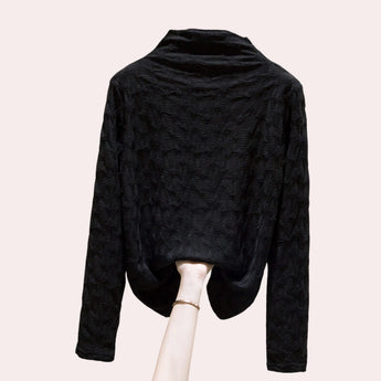 Women's high-collar top in black with a textured floral embossed pattern, featuring long sleeves and a sophisticated design.