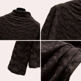 Textured black floral embossed high-collar women's top with long sleeves and intricate detailing on the fabric.