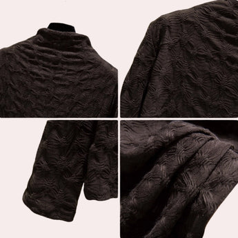 Textured black floral embossed high-collar women's top with long sleeves and intricate detailing on the fabric.