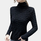 Textured black floral embossed high-collar women's top featuring long sleeves and a fitted waist, displayed against a neutral background.