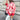 Red textured bomber jacket in stylish monochrome winter street style, worn by a person standing. The jacket features long sleeves, a high neck, and reaches the waist, offering a modern and fashionable look.