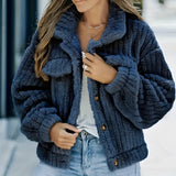 A person wearing a dark blue, 2XL textured grey chunky knit jacket styled for winter, paired with jeans. The individual is accessorized with a fedora hat and sunglasses, conveying an urban chic look.