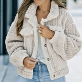 Textured grey chunky knit jacket styled with a white shirt underneath, worn by an individual dressed in jeans and accessorized with sunglasses and a fedora hat, showcasing an urban chic winter style.