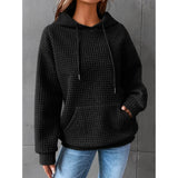Textured pink waffle knit hoodie displayed with a cozy women's winter pullover design, featuring a relaxed fit suitable for cold weather.